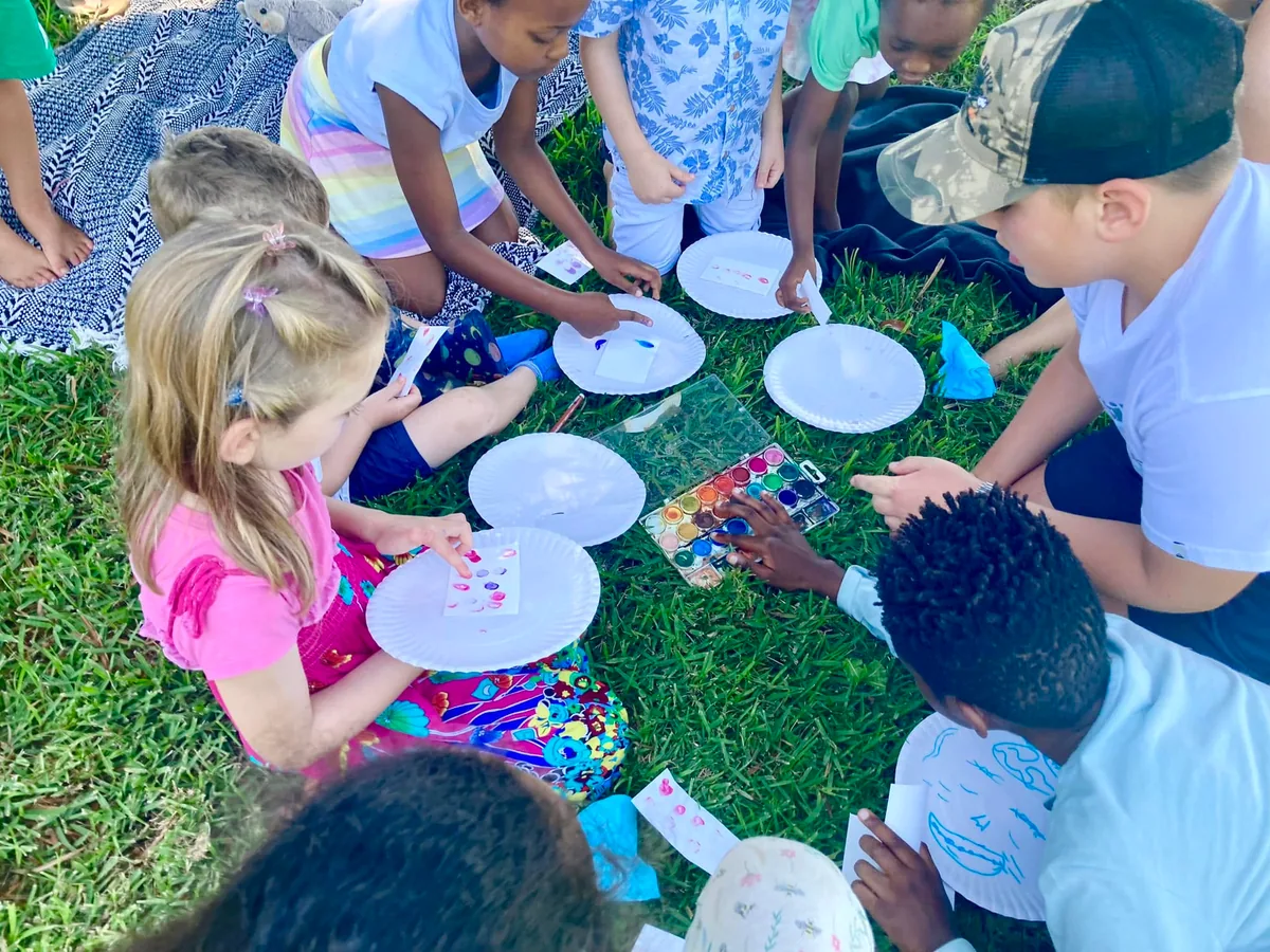 Children creating art together outdoors at Awaken Church