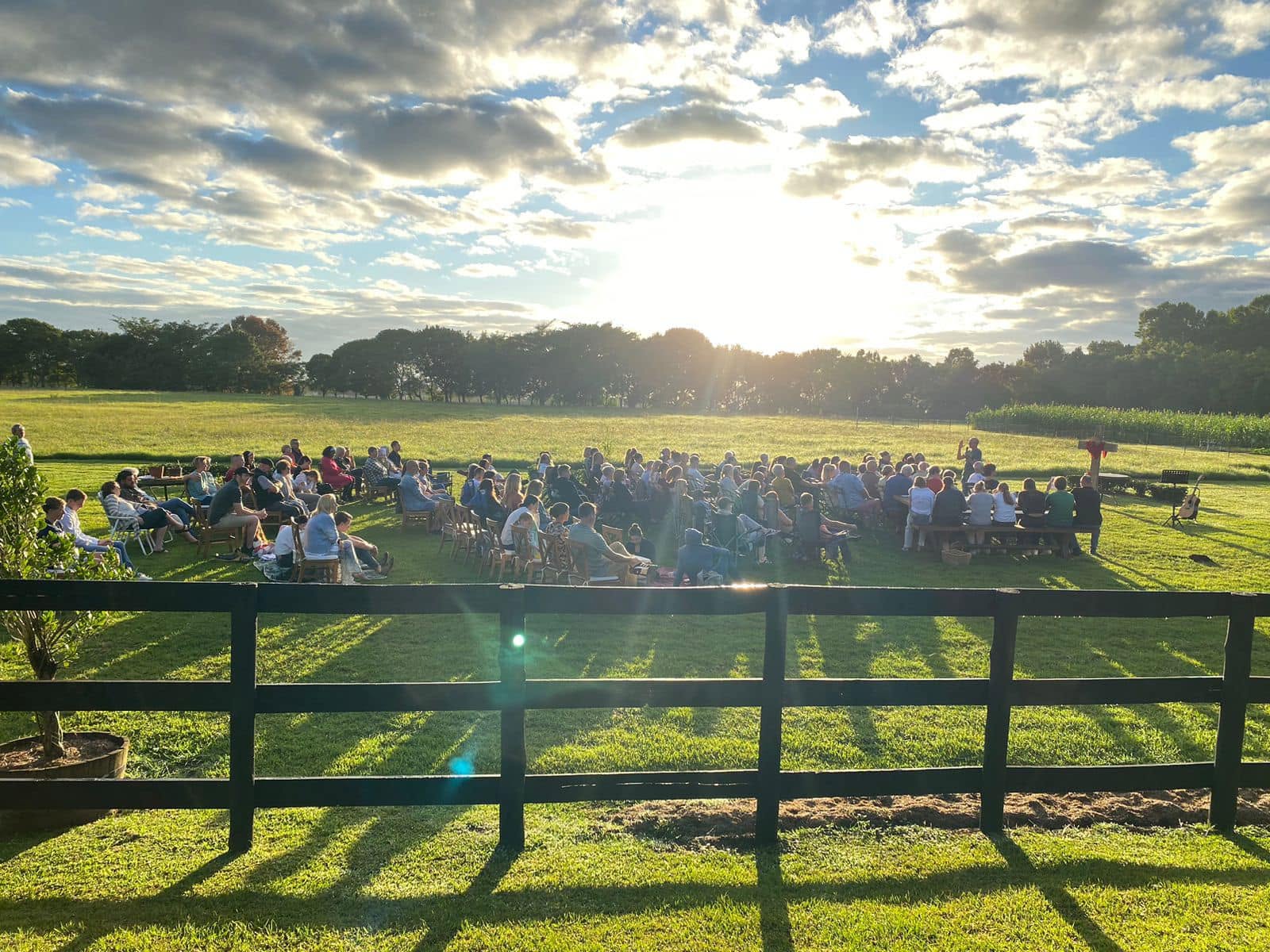 Awaken Church gathered outdoors at golden hour